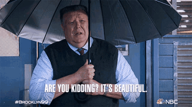 a man holding an umbrella with the words are you kidding it 's beautiful