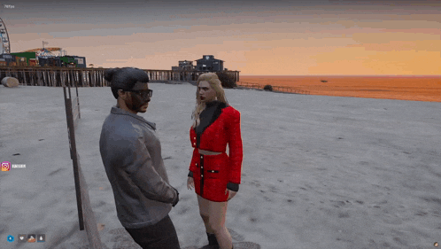 a man and a woman are standing on a sandy beach in a video game and the woman is wearing a red dress