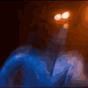 a blurry picture of a person 's face with a dark background