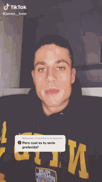 a man in a black hoodie is making a funny face while wearing a black hoodie .