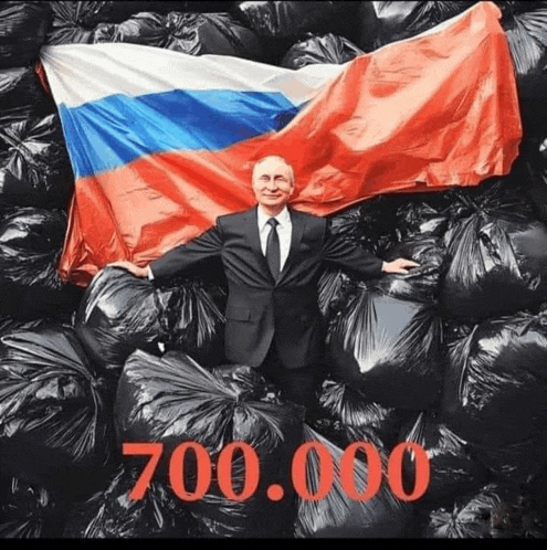 a man in a suit and tie holds a russian flag surrounded by black bags