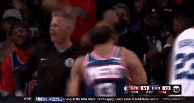 a basketball player in a jersey with the number 6 on it is standing in front of a referee .