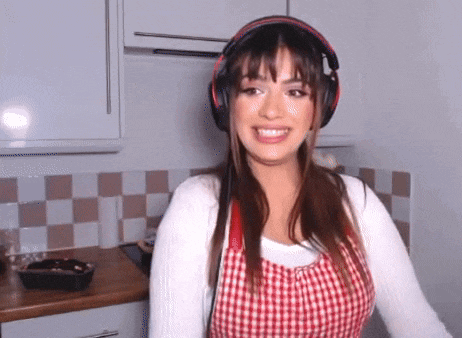a woman wearing headphones and an apron is smiling