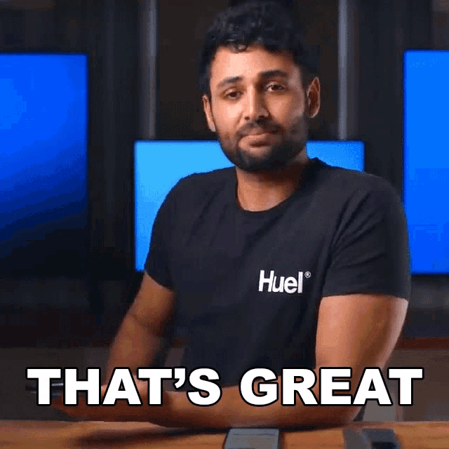 a man wearing a black t-shirt with the word huel on it