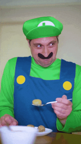 a man in a mario costume is holding a spoon in his hand