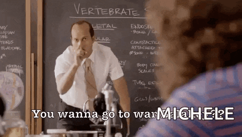 a man stands in front of a chalkboard with the word vertebrae written on it
