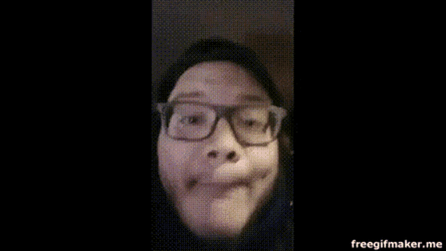 a close up of a person 's face with glasses .
