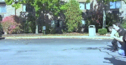 a couple of people sitting on a bench on the side of a street .
