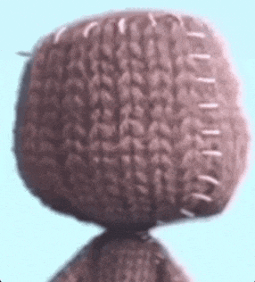 a close up of a stuffed animal 's head with stitches .