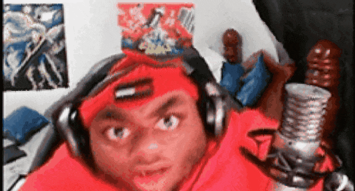 a man wearing headphones and a headband with the letter t on it