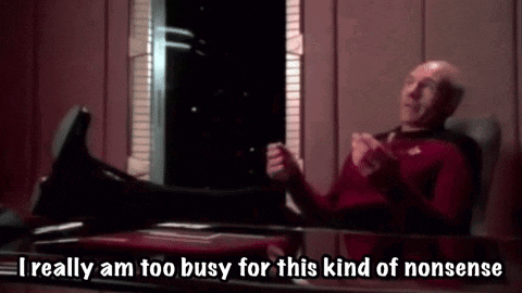 a man is sitting at a table with his feet up and says `` i really am too busy for this kind of nonsense ''
