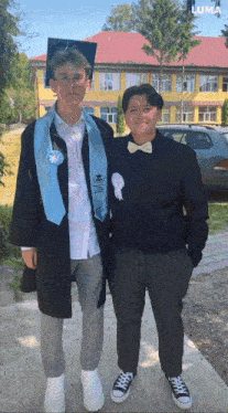 a man in a graduation cap and gown is standing next to another man