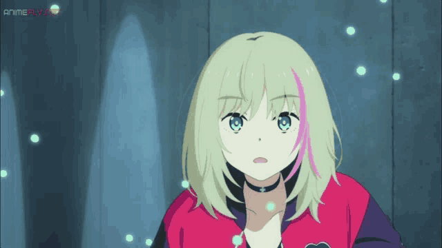 a girl with blonde hair and pink streaks looks at the camera
