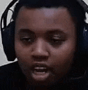 a close up of a man wearing headphones .