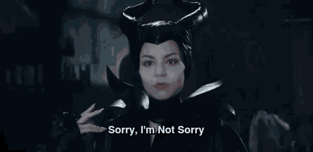 a woman in a maleficent costume is holding a knife and saying sorry , i 'm not sorry