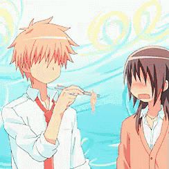 a boy and a girl are standing next to each other with a blue background