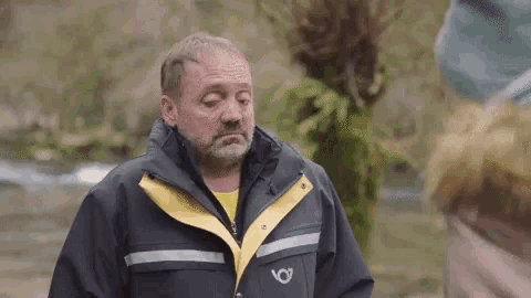 a man wearing a jacket with the letter o on the front