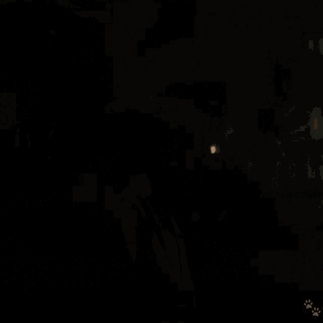 a woman in a dark room with a candle in the background is smiling .