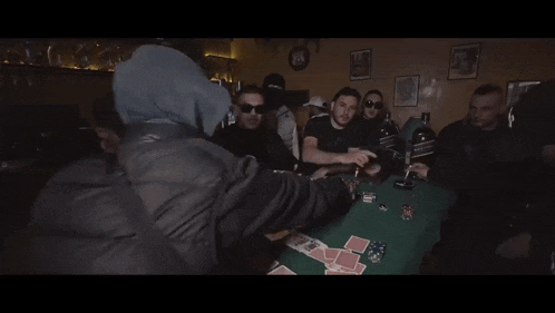 a group of men are playing poker with a bottle of jack daniels on the table