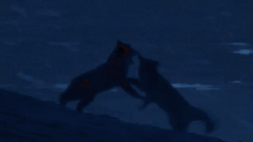 a man and woman are kissing in a dark room .