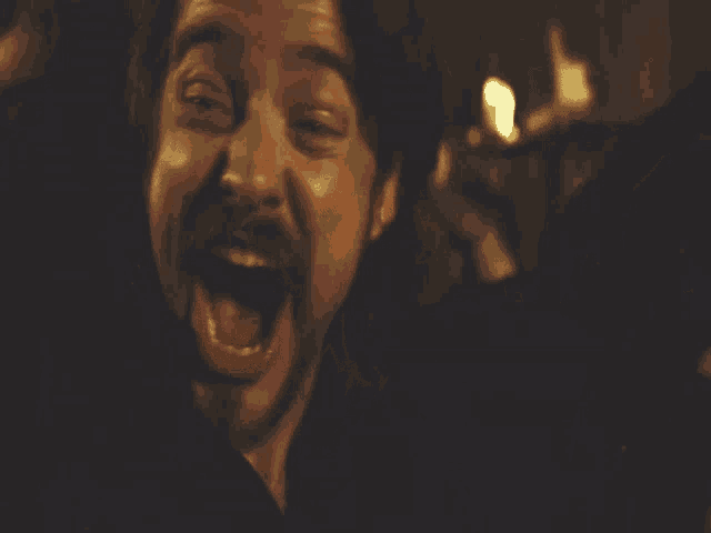 a man with a beard wearing headphones is smiling
