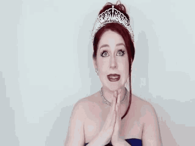a woman wearing a tiara and a blue dress says vote