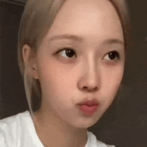 a close up of a young woman 's face without makeup .