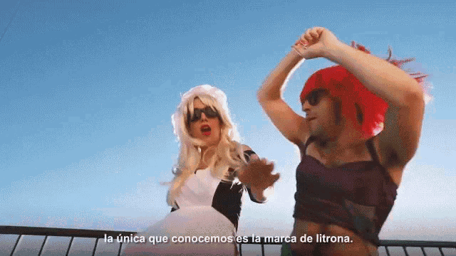 a man and a woman are dancing in front of a blue sky with la unica que conocemos es la marca de litrona