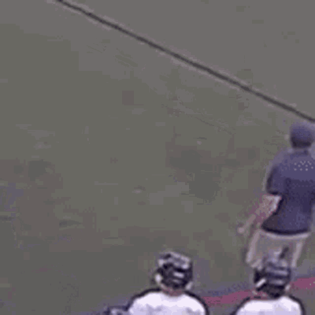 a group of lacrosse players are standing on a field .