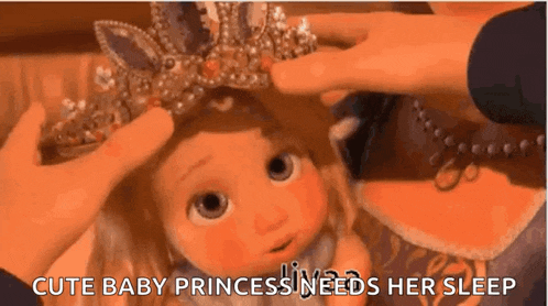 a baby princess is wearing a tiara and needs her sleep .