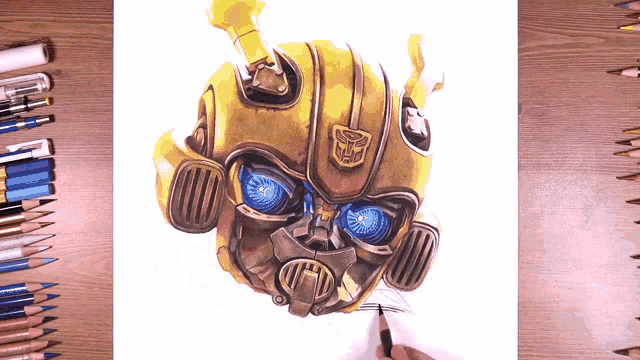 a drawing of bumblebee from transformers is on a table surrounded by colored pencils