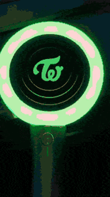 a glowing circle with the letter t in the center