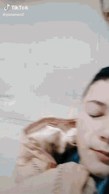 a tiktok video of a boy and a cat is being shared