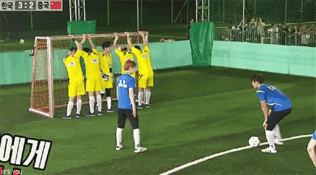 a group of soccer players on a field with the scoreboard showing 8:32