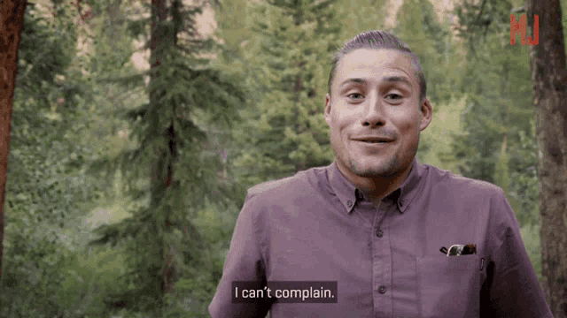 a man wearing a purple shirt says i can 't complain