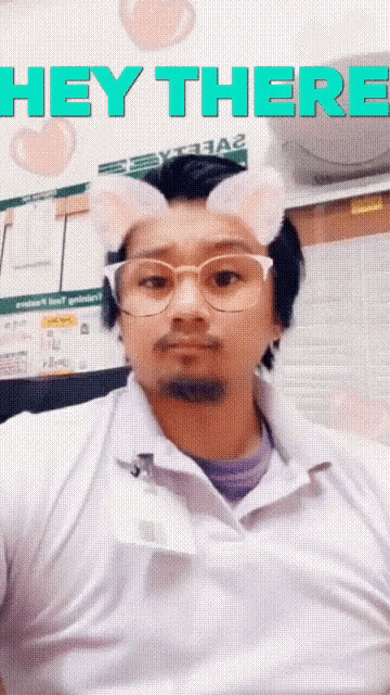 a man wearing cat ears and glasses with the words hey there above him