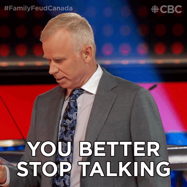 a man in a suit and tie is giving a speech and says you better stop talking