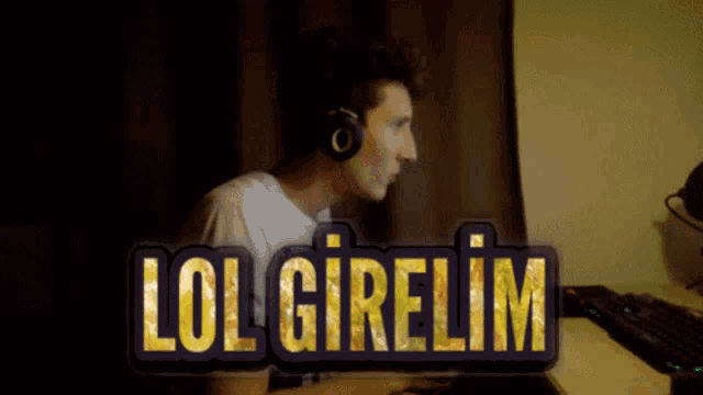 a man wearing headphones sits at a desk with the words lol girelim written in gold