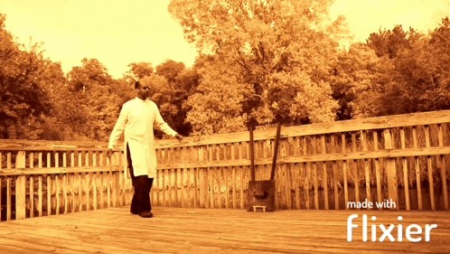 a man is standing on a wooden deck with the words made with flixier on the bottom