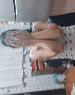 a woman is covering her face with her hands