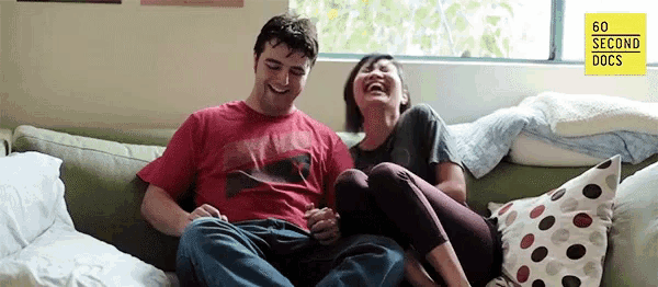 a man and a woman are sitting on a couch and laughing with the words 60 sec docs on the bottom