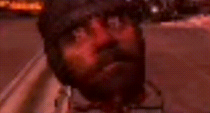 a blurry picture of a person 's face with a red light behind them .