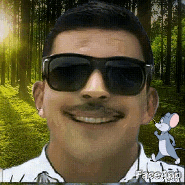 a man wearing sunglasses and a mustache is smiling in front of a tom and jerry cartoon