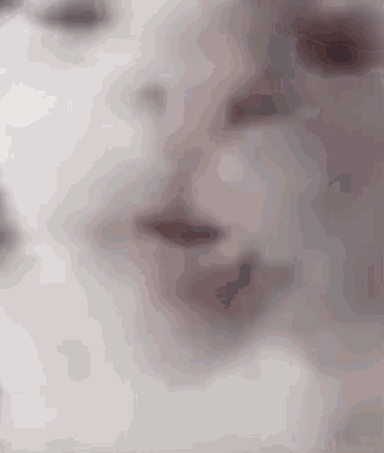 a close up of a person 's face with a blurry background