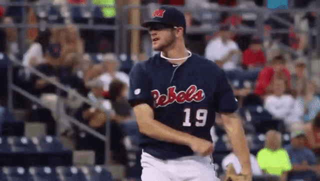 a baseball player with the number 19 on his jersey is standing on the field