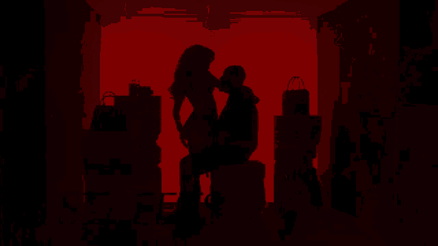 a red background with a black object in the center
