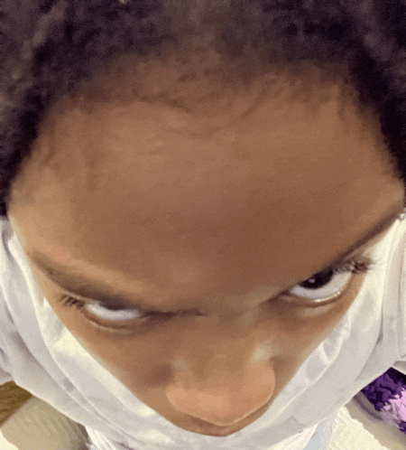 a close up of a person 's face with a white shirt