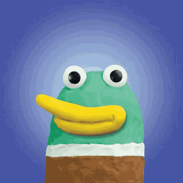 a green duck with a yellow beak and big eyes on a blue background