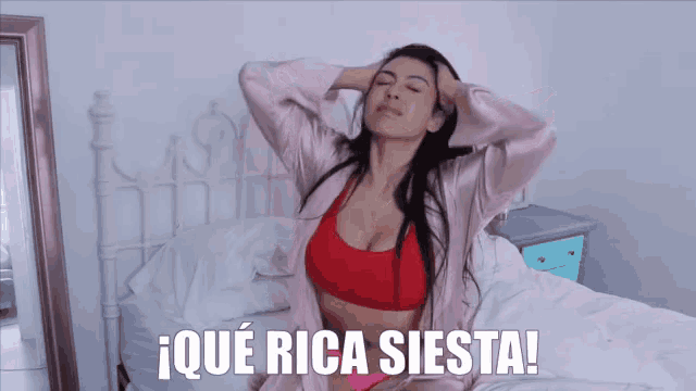 a woman in a red bra is sitting on a bed with the words ique rica siesta written above her