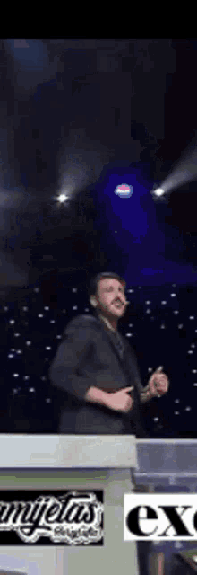 a man in a suit is standing in front of a podium that says ' champions ' on it